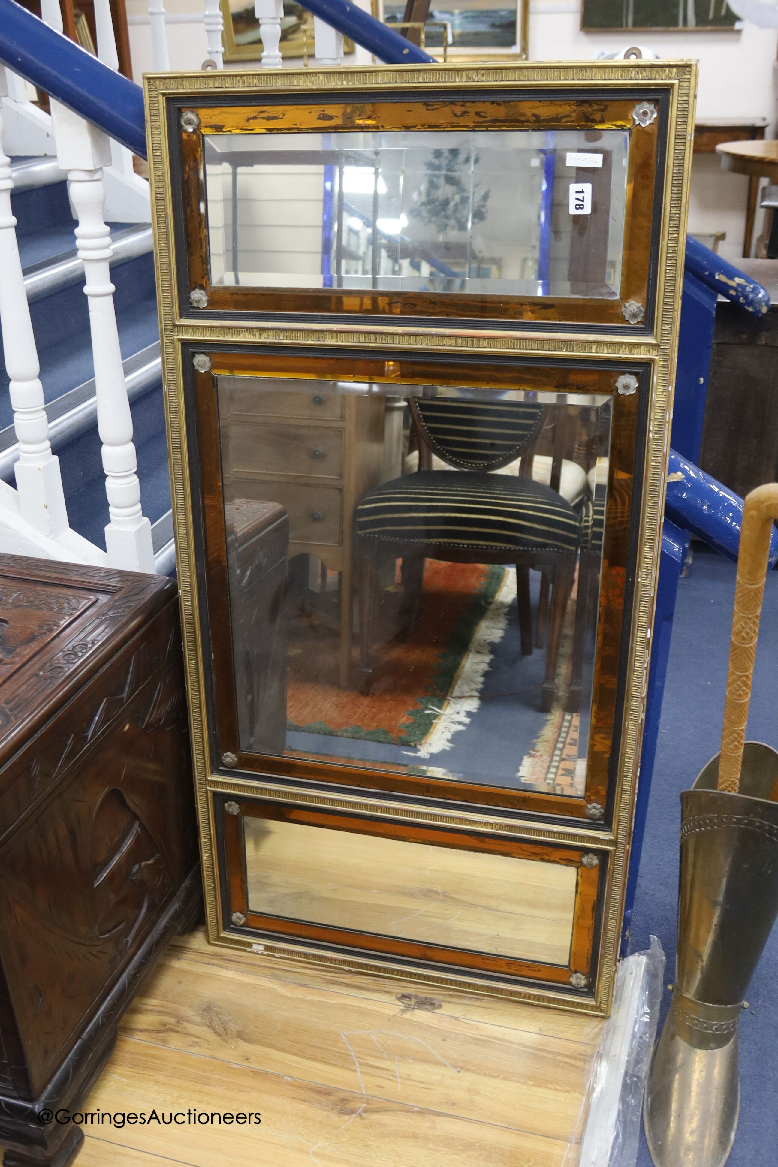 An 18th century moulded gilt overmantel, three mirror plates and amber glass borders and clear glass rosettes